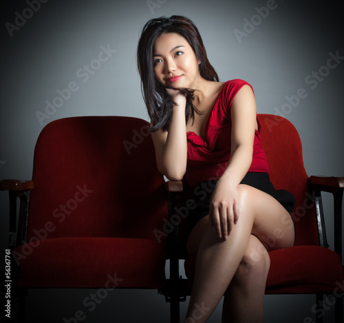 Attractive Asian girl 20s at the theatre isolate white backgroun
