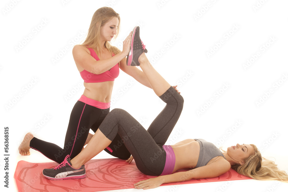 woman stretch another woman's leg woman stretch another woman's leg