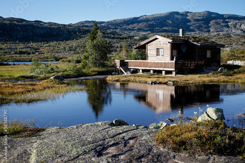small hut at norwegian lake in hardanger vidda