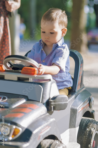 Portrait of Little Boy Managing to Drive a Scale Model