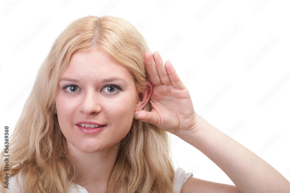 woman eavesdropping with hand behind her ear woman eavesdropping with hand behind her ear