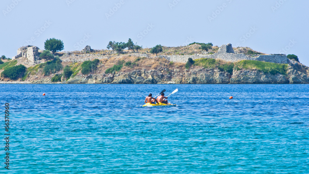 Kayaking on a vacation in front of an old roman fortress ruins