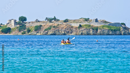 Kayaking on a vacation in front of an old roman fortress ruins