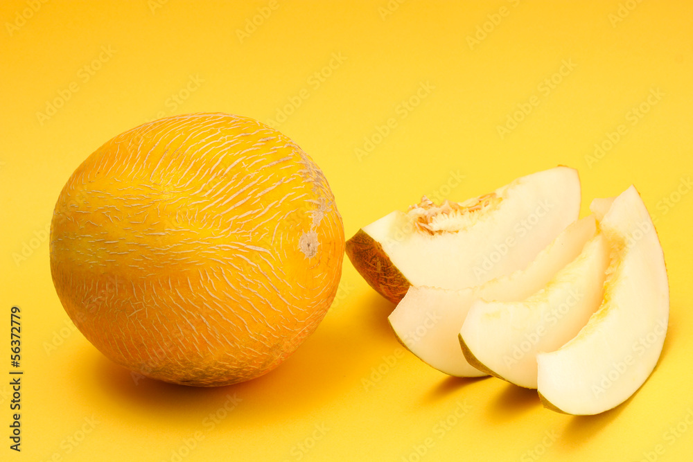 ripe sweet melons, on yellow background ripe sweet melons, on yellow background