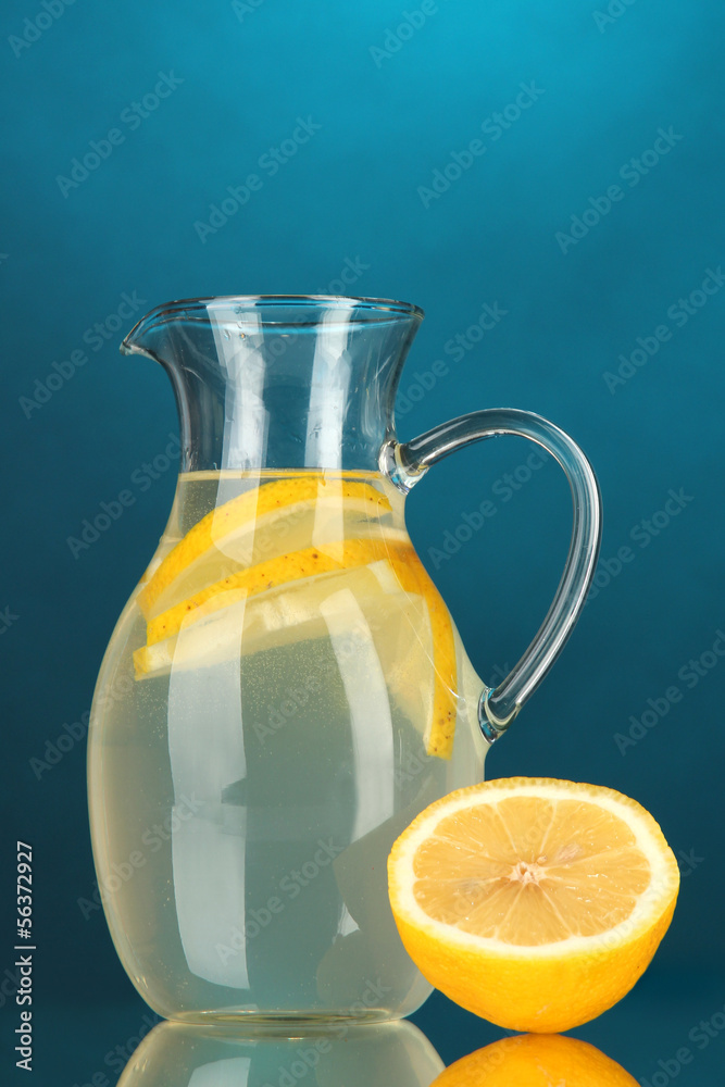 Lemonade in pitcher on blue background Lemonade in pitcher on blue background
