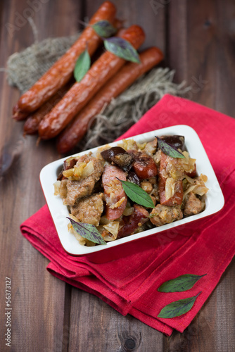 Polish traditional stew bigos on a rustic wooden background photo