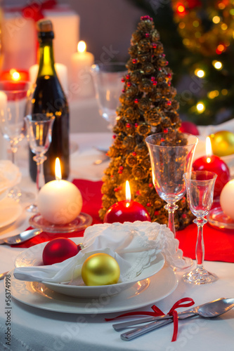 Candlelight on a table decorated beautifully for Christmas