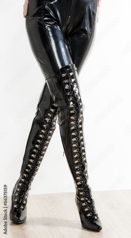 detail of standing woman wearing extravagant clothes and boots detail of standing woman wearing extravagant clothes and boots