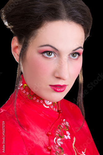 poortrait of young beautiful geisha over black photo