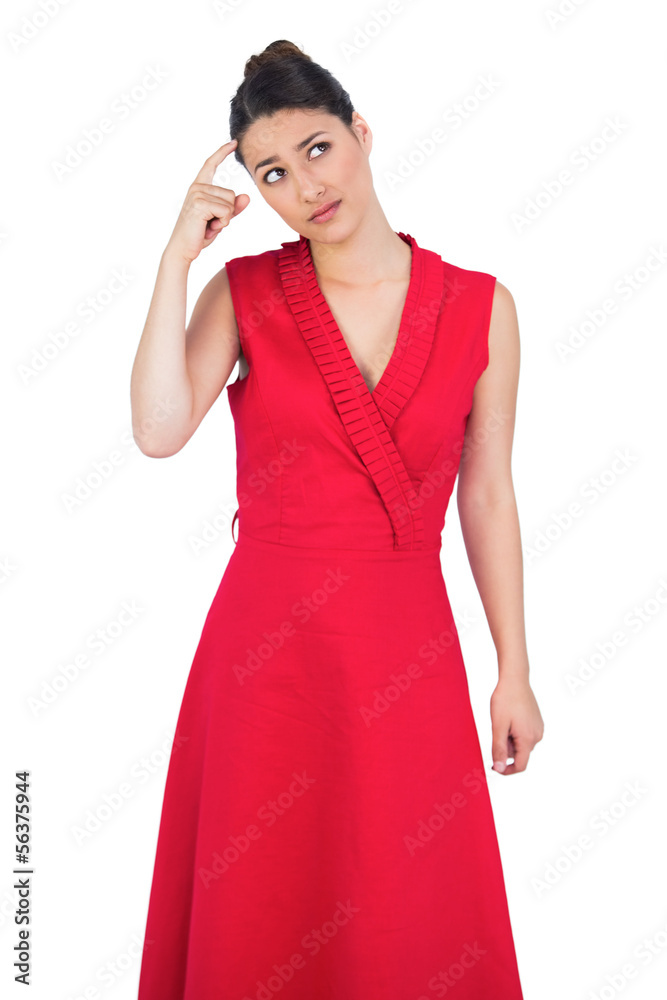 Thoughtful glamorous model in red dress posing Thoughtful glamorous model in red dress posing