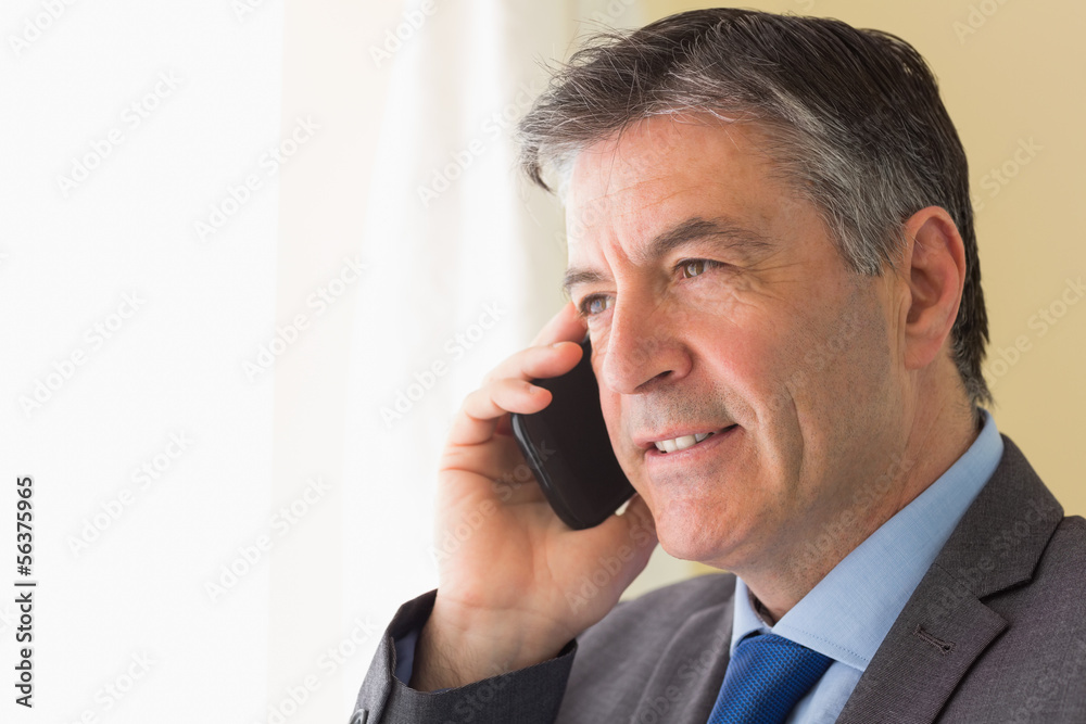 Concentrated man calling someone with his mobile phone Concentrated man calling someone with his mobile phone