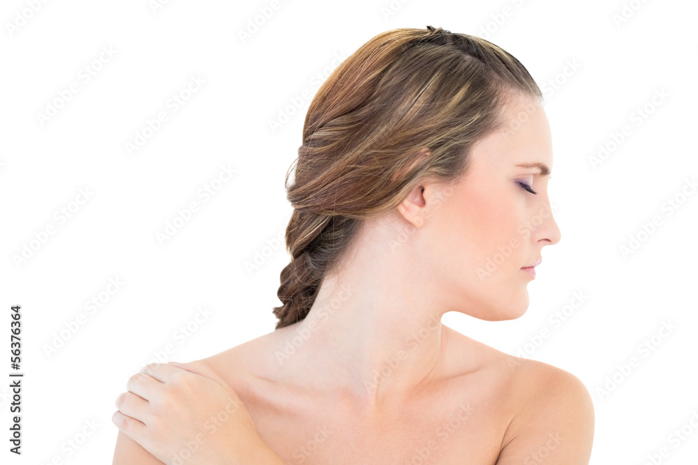 Woman looking aside with one hand on shoulder eyes closed Woman looking aside with one hand on shoulder eyes closed