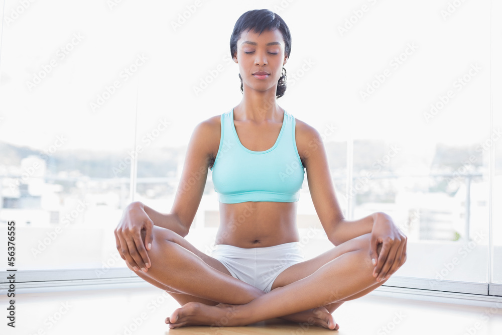 Fototapeta premium Meditative black haired woman doing yoga