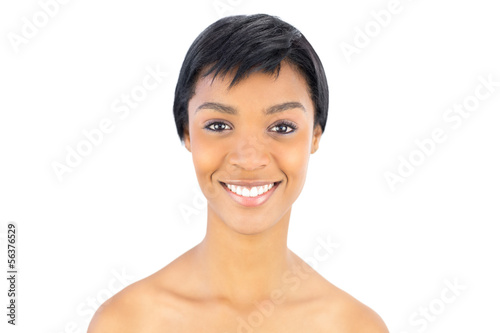 Cheerful black haired woman posing looking at camera