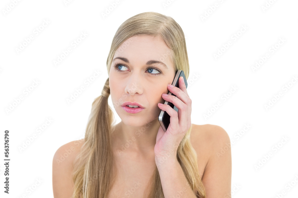 Serious young blonde woman making a phone call Serious young blonde woman making a phone call