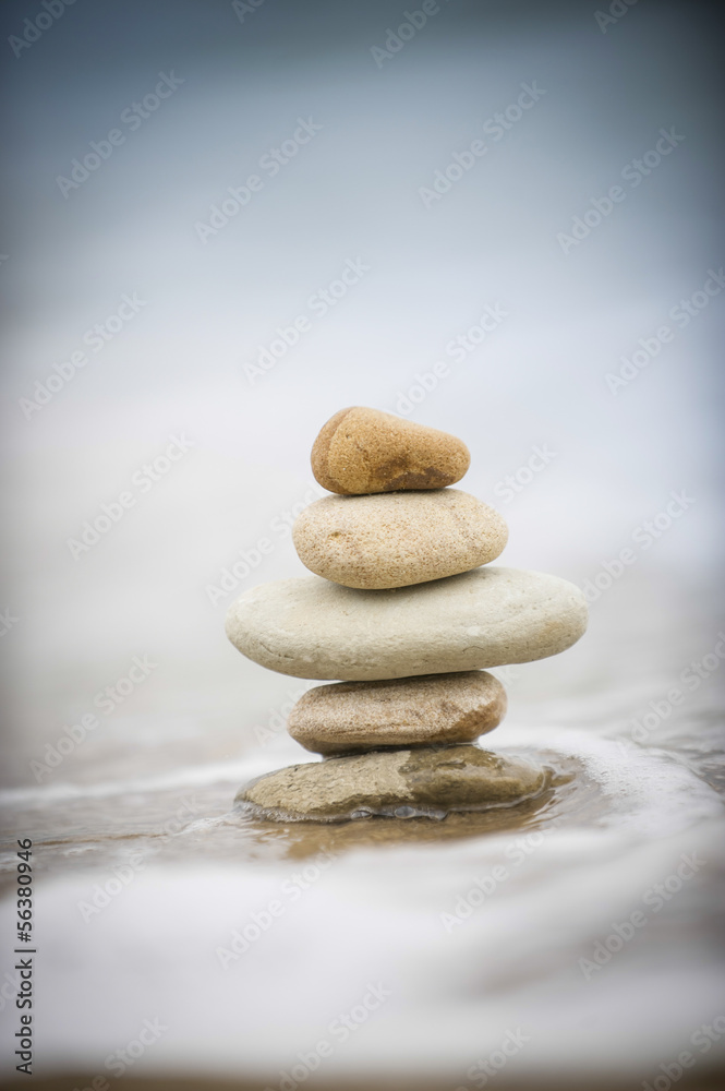 Stones piled up with tide coming in around it Stones piled up with tide coming in around it