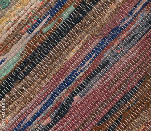 Closeup of old worn out striped rag rug