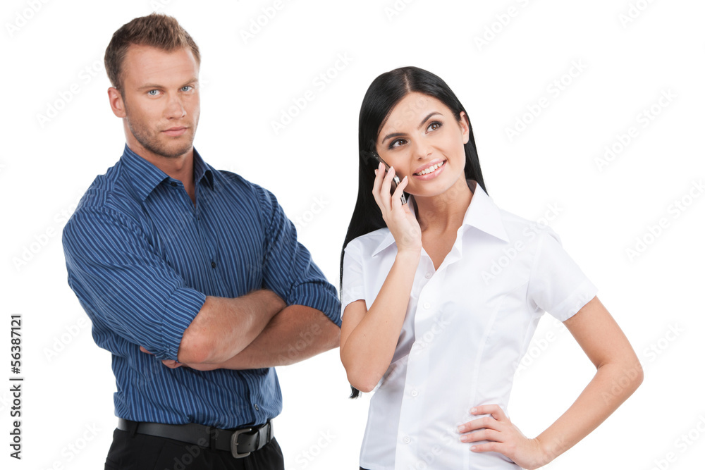 Business people. Young man and woman standing close to each othe Business people. Young man and woman standing close to each othe