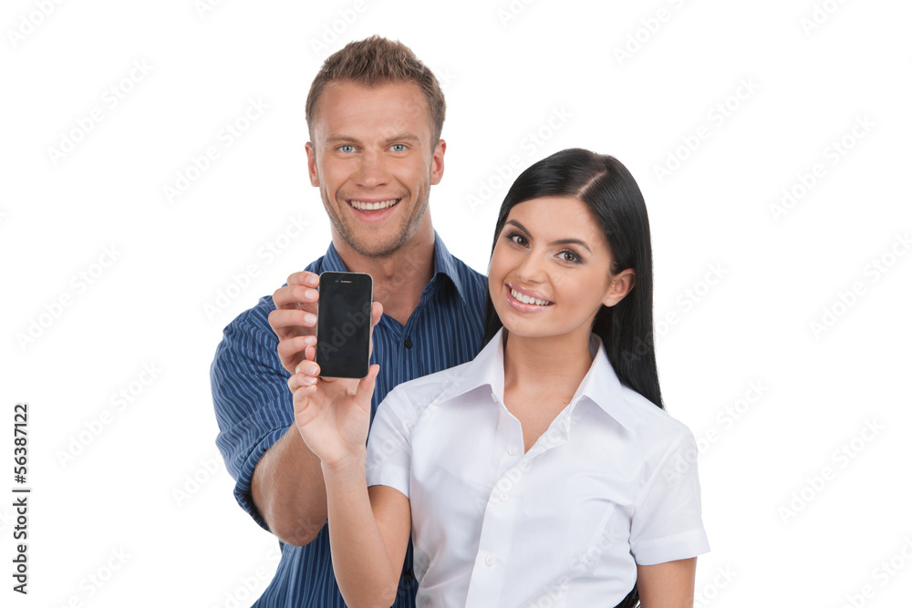 People with mobile phone. Young man and woman holding a mobile p People with mobile phone. Young man and woman holding a mobile p