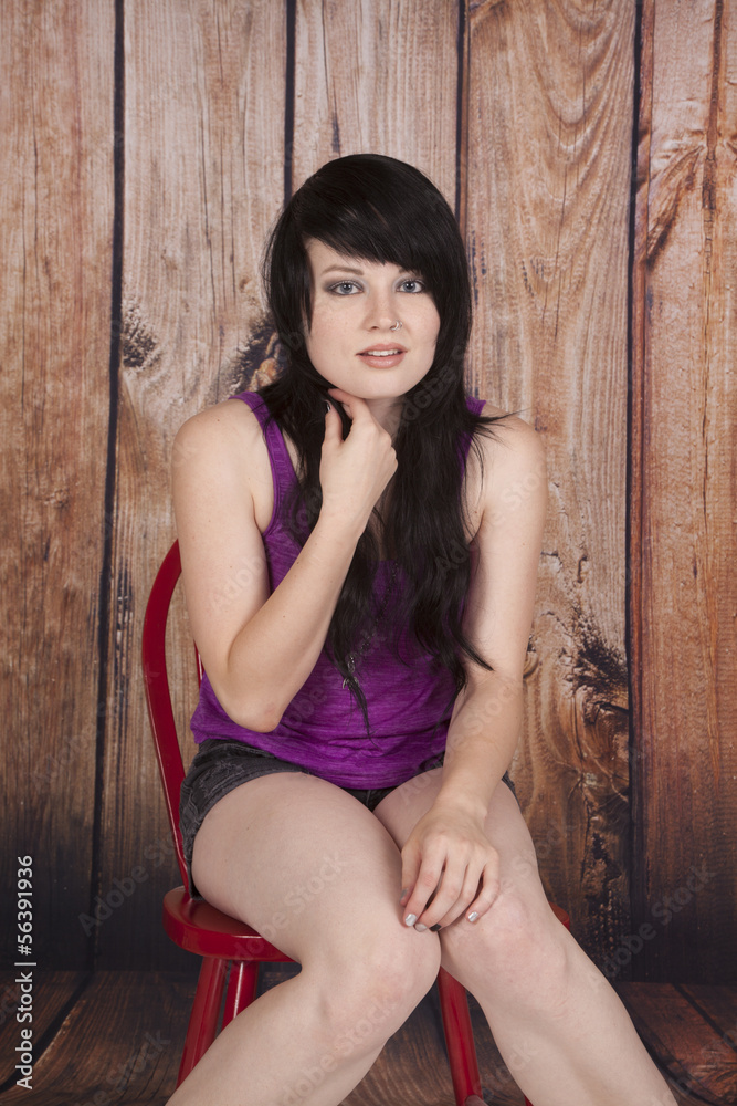 Fototapeta premium woman sit red chair wood background face