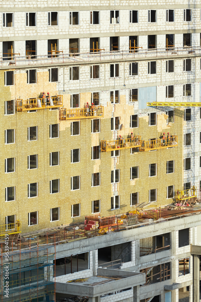 Building under construction, facade weatherization works Building under construction, facade weatherization works