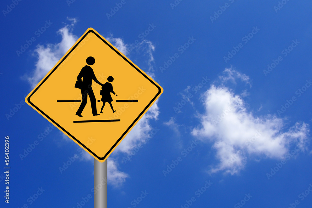 Walking across the street signs against blue sky Walking across the street signs against blue sky