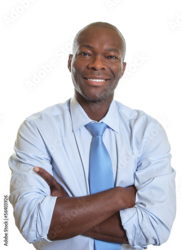 Smiling african businessman with crossed arms and tie photo