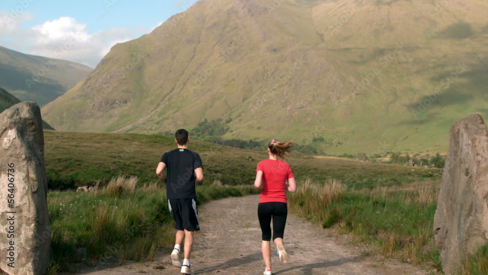 Man jogging and is met by his jogging girlfriend Man jogging and is met by his jogging girlfriend