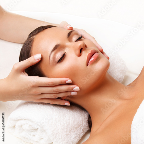 Photo Face Massage.  Close-up of a Young Woman Getting Spa Treatment.