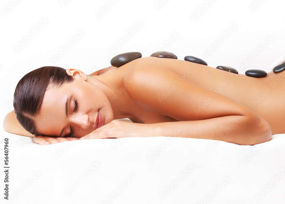 Stone Massage. Beautiful Woman Getting Spa Hot Stones Massage. S