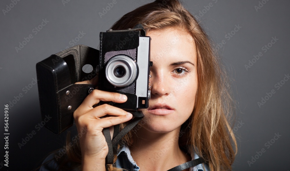 Photographer woman holding old camera, taking pictures Photographer woman holding old camera, taking pictures