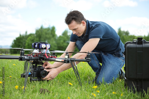 Technician Fixing Camera On UAV Helicopter