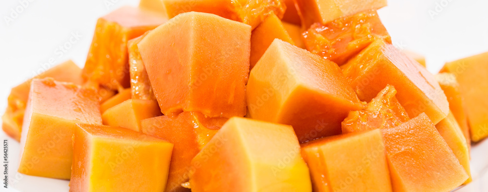 Bite size papaya fruits over white background Bite size papaya fruits over white background