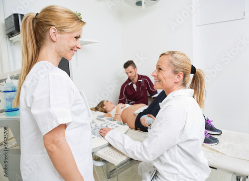 Happy Obstetricians With Expectant Couple