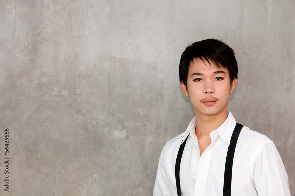 A teenager boy with white shirt and suspenders A teenager boy with white shirt and suspenders