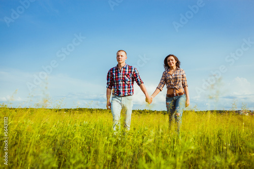 couple walking through the field