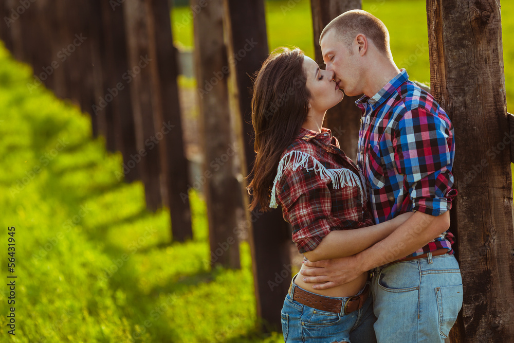 Fototapeta premium couple on the farm stading near fence