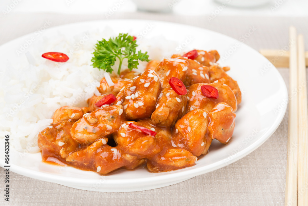 chicken fillet in tomato sauce with sesame seeds, rice close-up chicken fillet in tomato sauce with sesame seeds, rice close-up