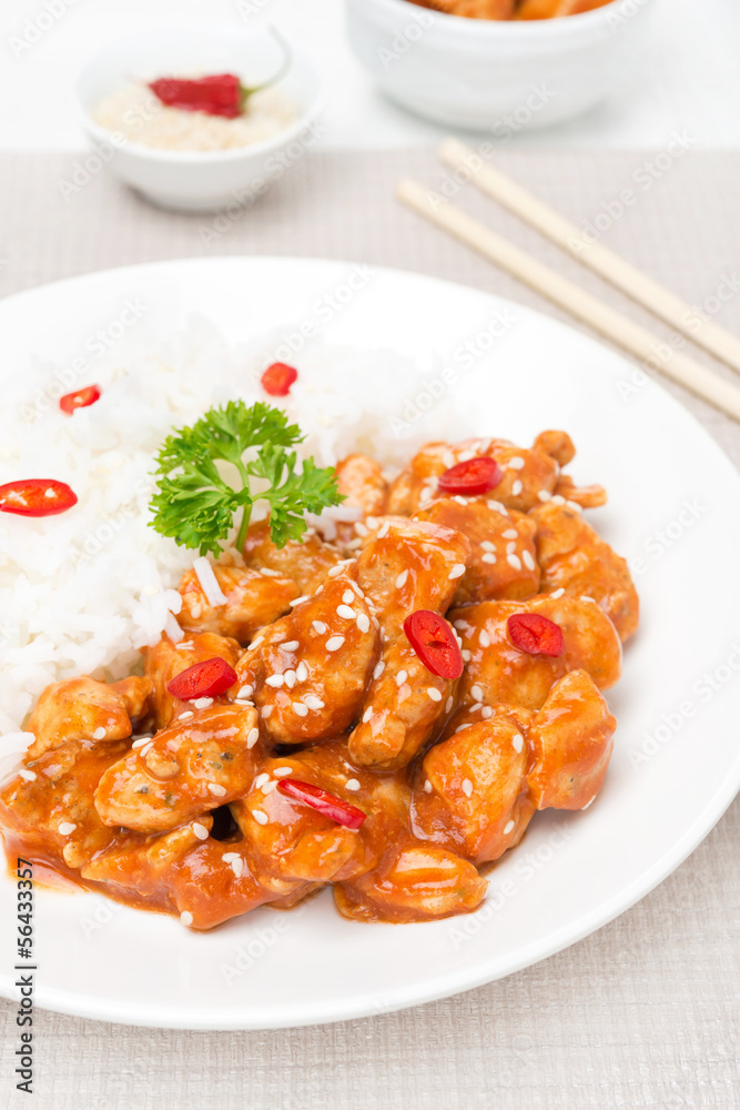 chicken fillet in tomato sauce with sesame seeds and rice