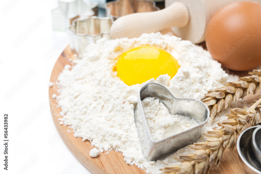 flour, eggs, rolling pin and baking forms on wooden board flour, eggs, rolling pin and baking forms on wooden board