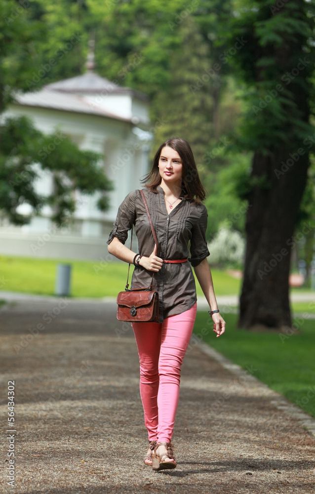 Young Woman Walking in a Park Young Woman Walking in a Park