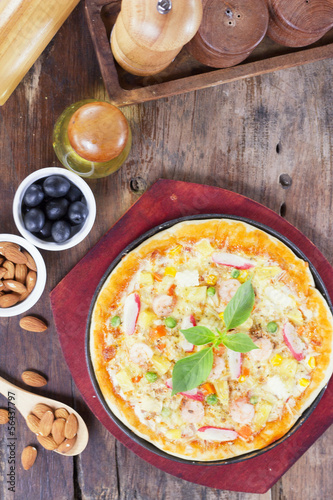 Fresh pizza on a wooden board