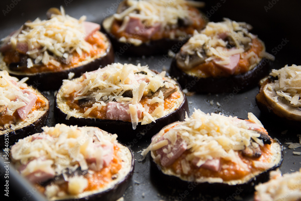 Slice of fried aubergines with tomato sauce, mushrooms, ham and