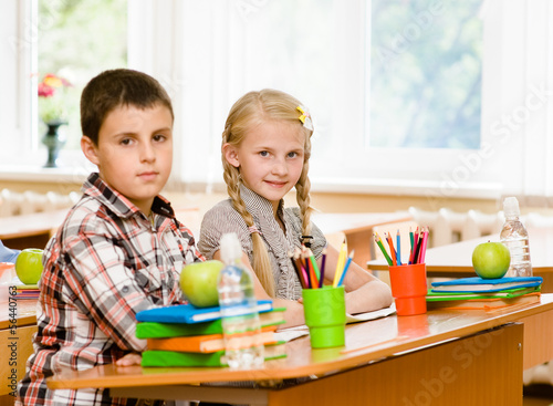 Portrait of schoolkids looking at camera at workplace photo