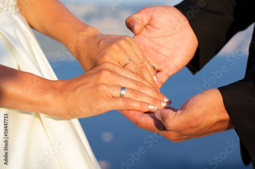 Wedding couple holding hands on sea background