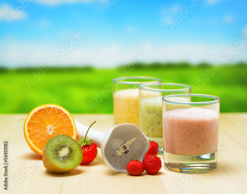 Fruit smoothie on wooden table on rural background