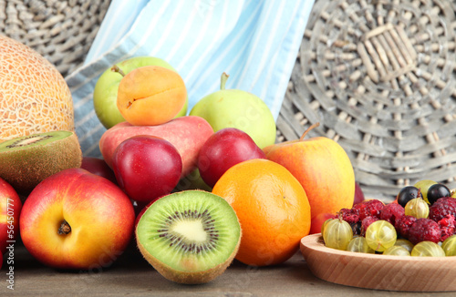 Assortment of juicy fruits  on wooden background