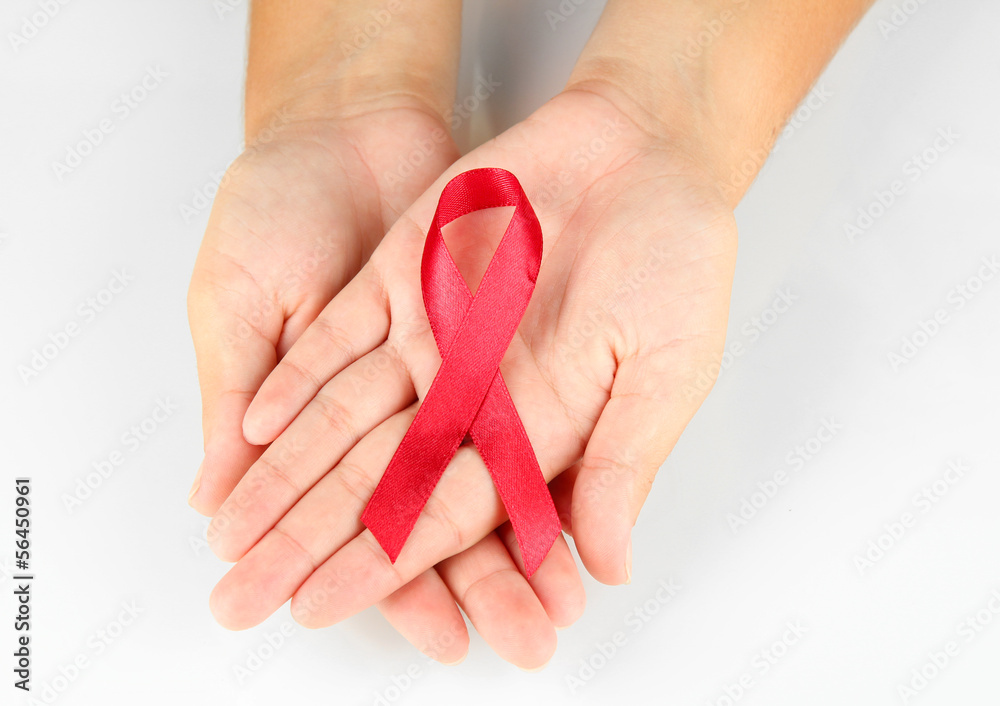 AIDS ribbon in hands isolated on white AIDS ribbon in hands isolated on white
