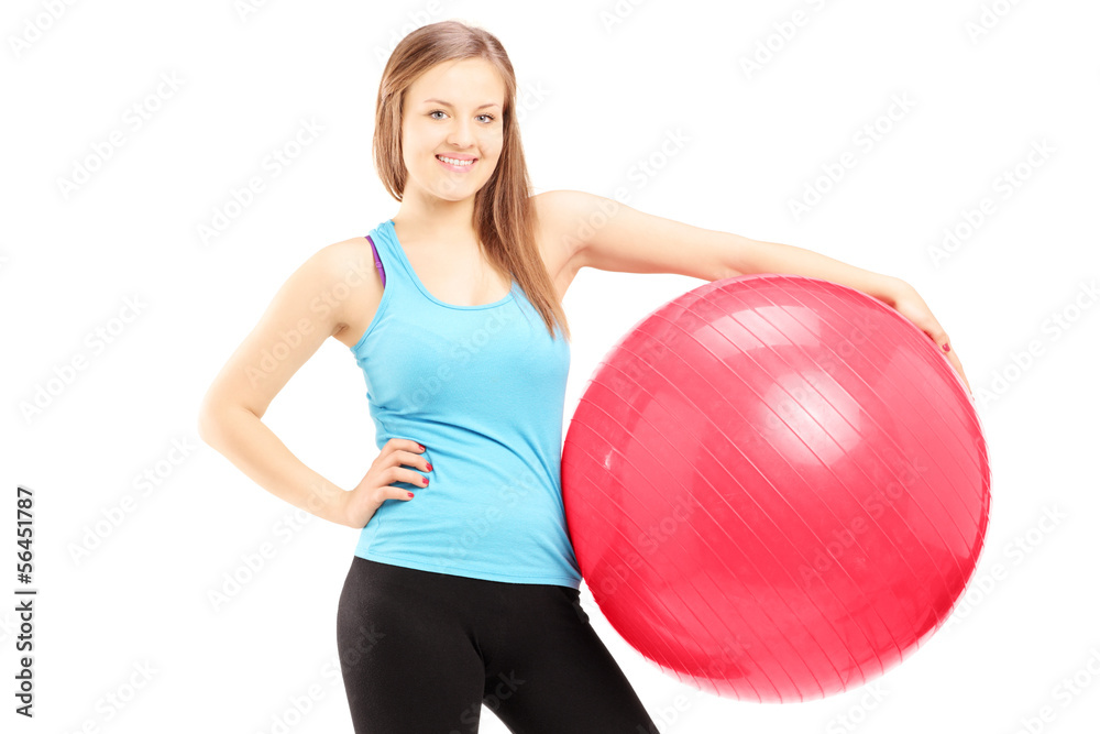 Young female athlete holding a fitness ball Young female athlete holding a fitness ball