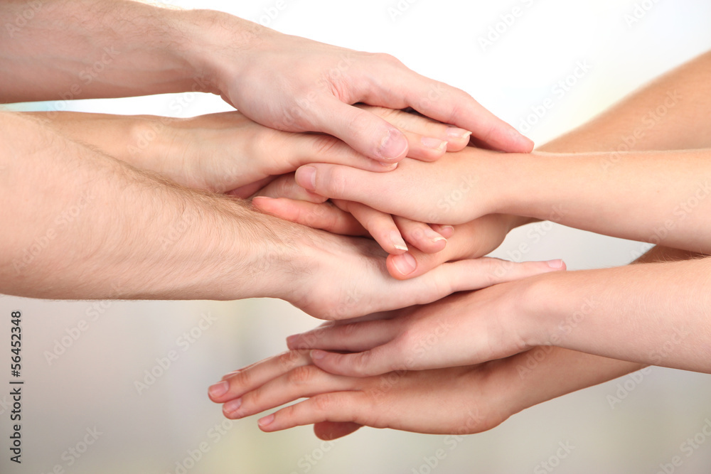 United hands on bright background. Conceptual photo of teamwork United hands on bright background. Conceptual photo of teamwork